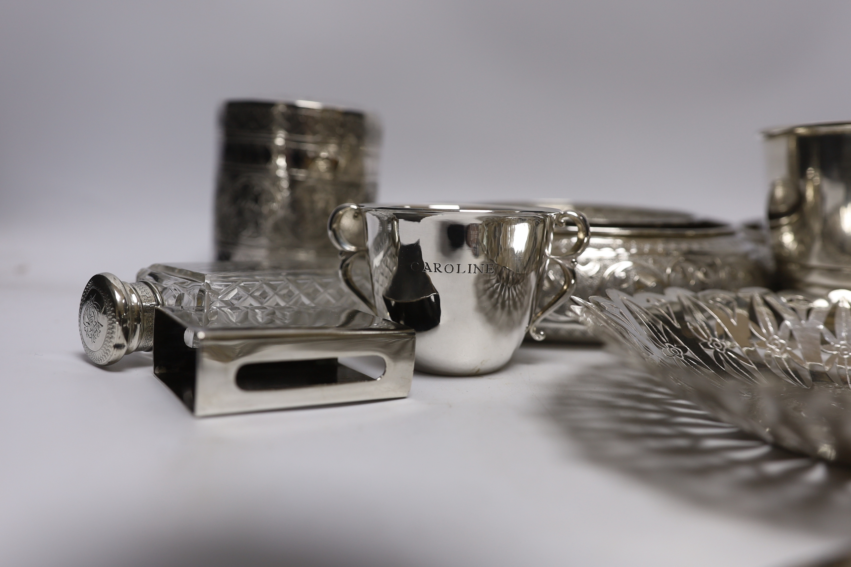 A group of silver and a white metal items including two Middle Eastern ring vases, two foliate dishes, a vase and a canister, together with a silver christening mug, 800 standard beaker, silver fish slice, two mounted gl